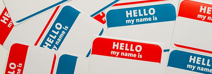 A stack of blue and red "Hello, my name is" name tags or badges